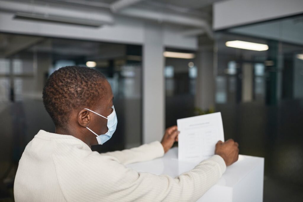 A Man Dropping a Paper in a Box